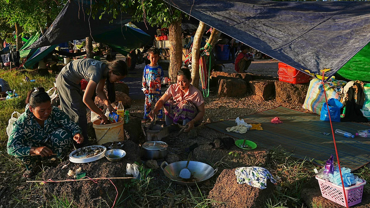 Displaced residents prepare breakfast in Cambodia.