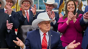Donald Trump tries on a hat gifted by the 1980 US Olympic hockey team in Washington.