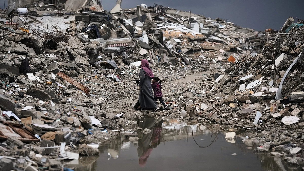 Palestinians navigate rubble amid stormy weather in Gaza City.