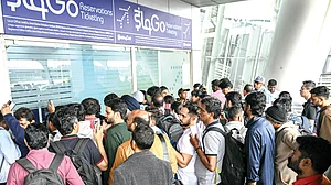 Passengers queue up at an IndiGo kiosk at Chennai airport, 5 Dec
