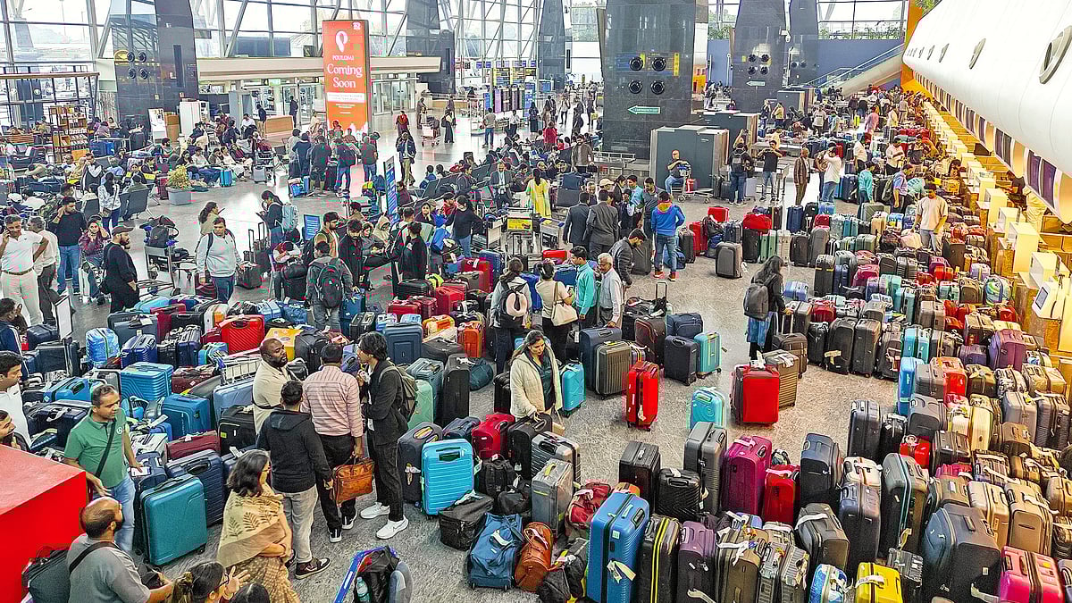 Passengers try to identify luggage at Bengaluru airport after IndiGo cancelled hundreds of flights