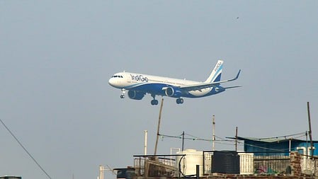 An aircraft descends for landing at Delhi airport.