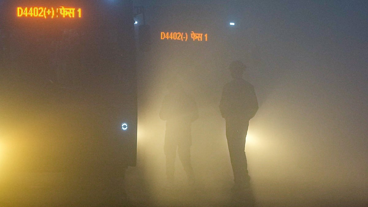 Citizens brave dense fog on a winter morning, at Mayur Vihar area, in New Delhi.
