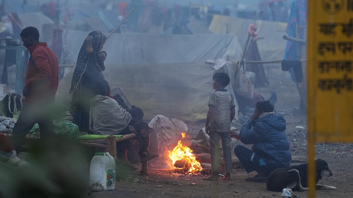 People warm themselves near a makeshift fire in New Delhi.