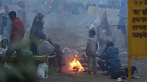 People warm themselves near a makeshift fire in New Delhi.