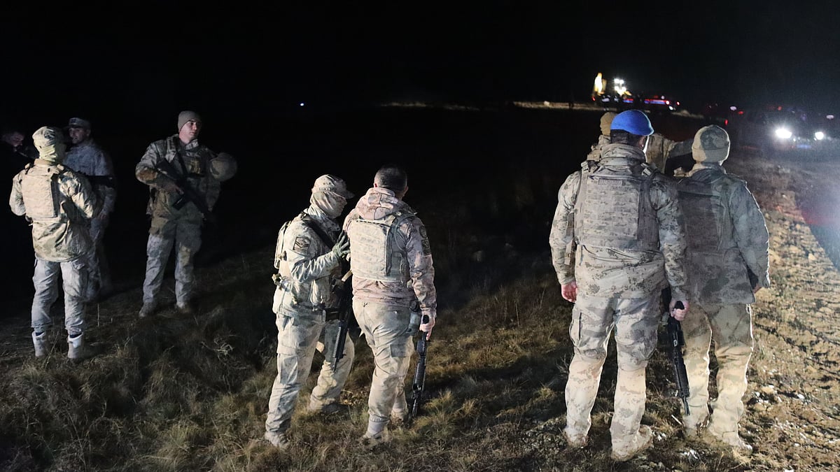 Turkish soldiers search for the remains of a private jet carrying Libya's military chief. 