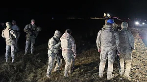 Turkish soldiers search for the remains of a private jet carrying Libya's military chief.