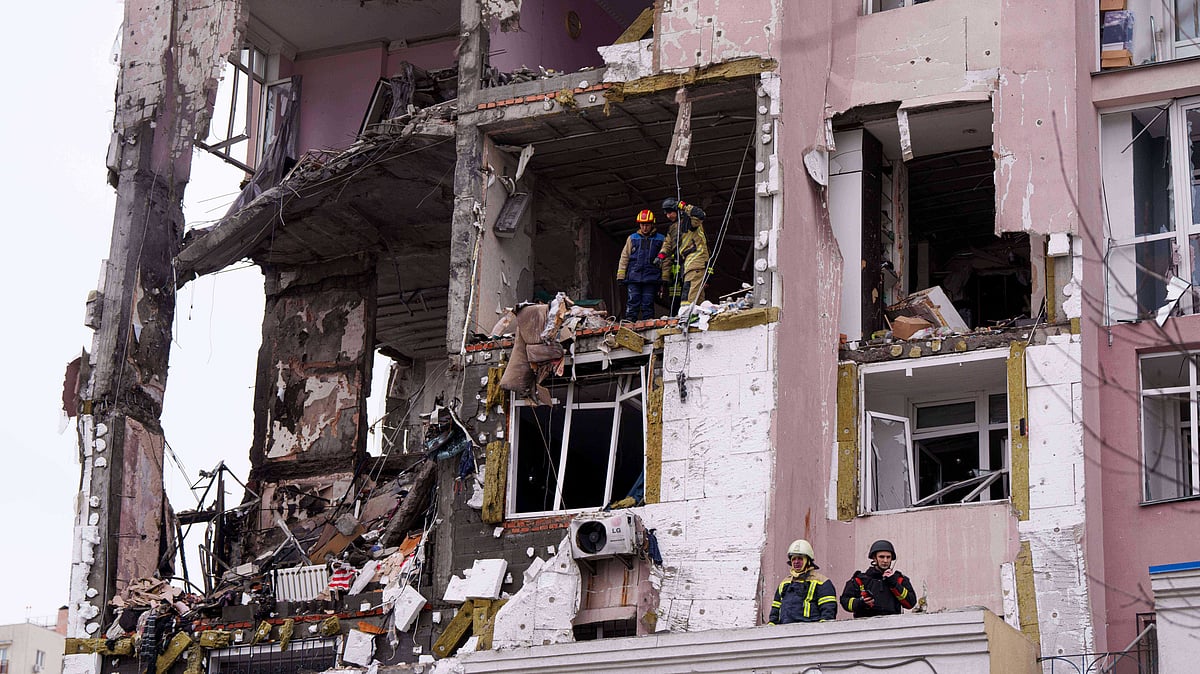 Rescue workers at a residential building heavily damaged by a Russian strike on Kyiv, 27 Dec