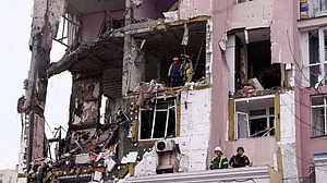 Rescue workers at a residential building heavily damaged by a Russian strike on Kyiv, 27 Dec