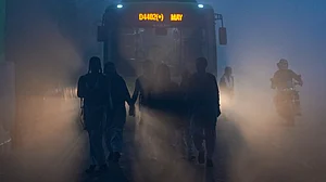 Students make their way to school through dense winter fog in New Delhi on 29 December.