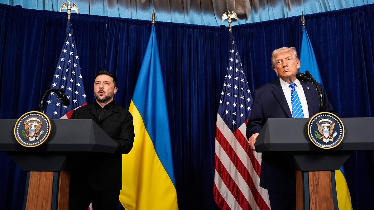 Donald Trump listens as Volodymyr Zelenskyy speaks at a news conference following their meeting
