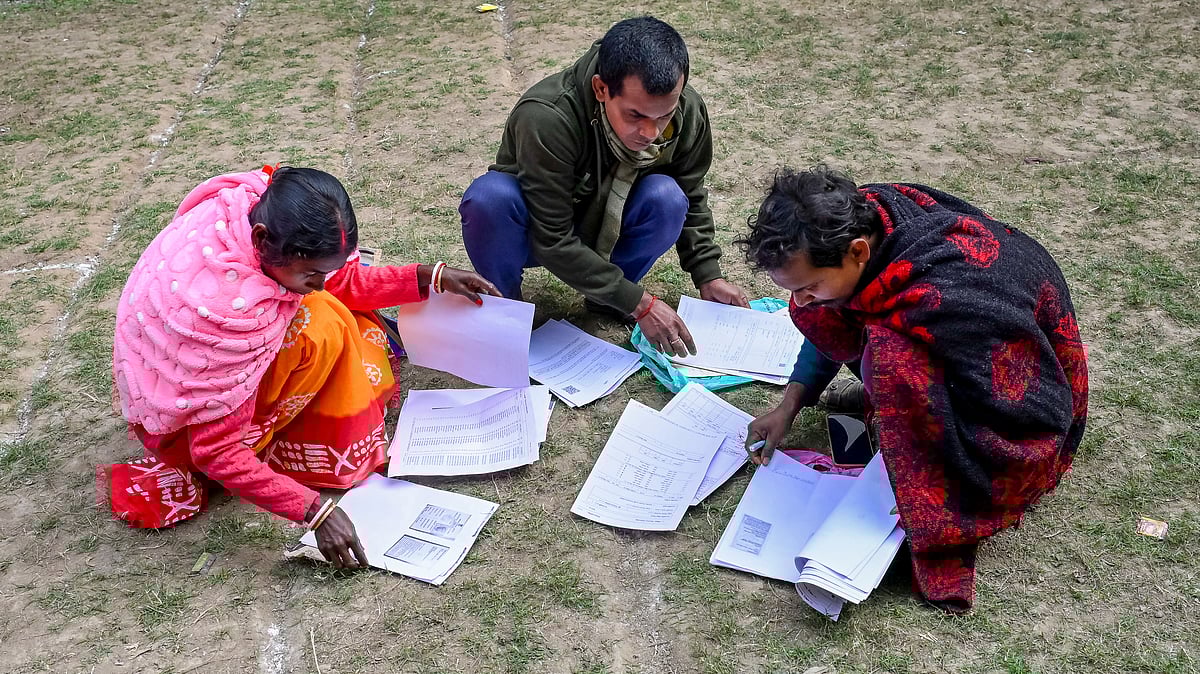 People checking their documents during SIR hearings in West Bengal 