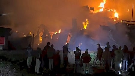 Flames engulf Birati’s bustling Jadu Babu’s market.