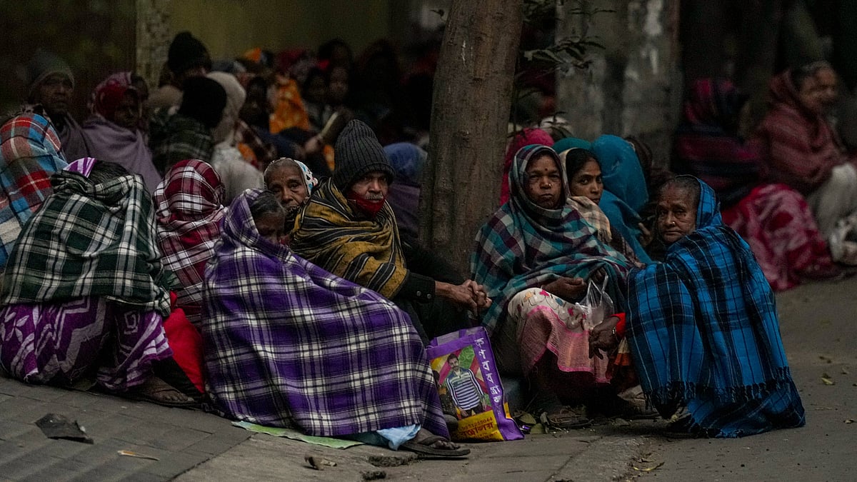 People huddle in woollens on a Kolkata pavement as winter’s chill tightens its grip on the city.