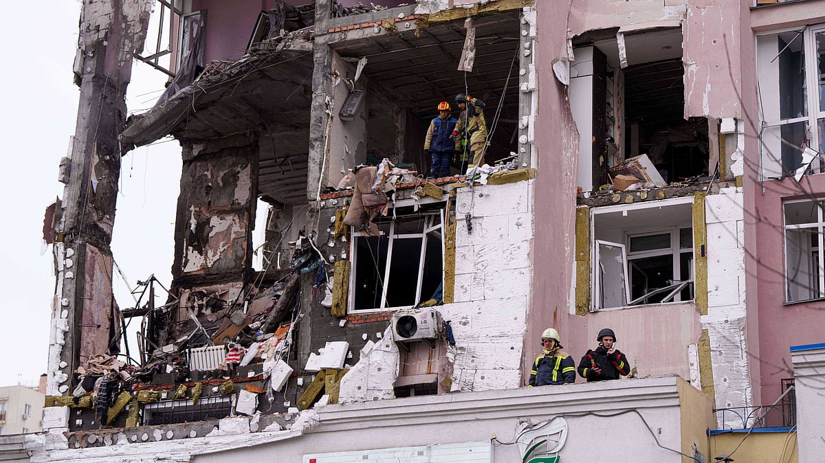 Rescue workers clear rubble after a Russian strike hits a residential building in Kyiv.