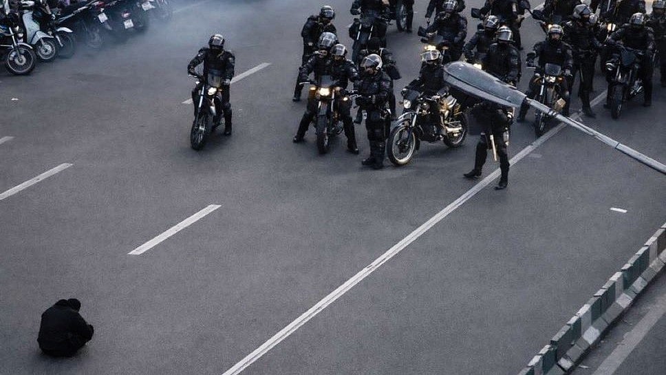 A lone protester faces security forces in Iran