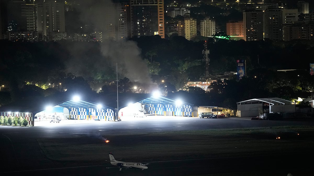 Smoke raises at La Carlota airport after explosions in Caracas.
