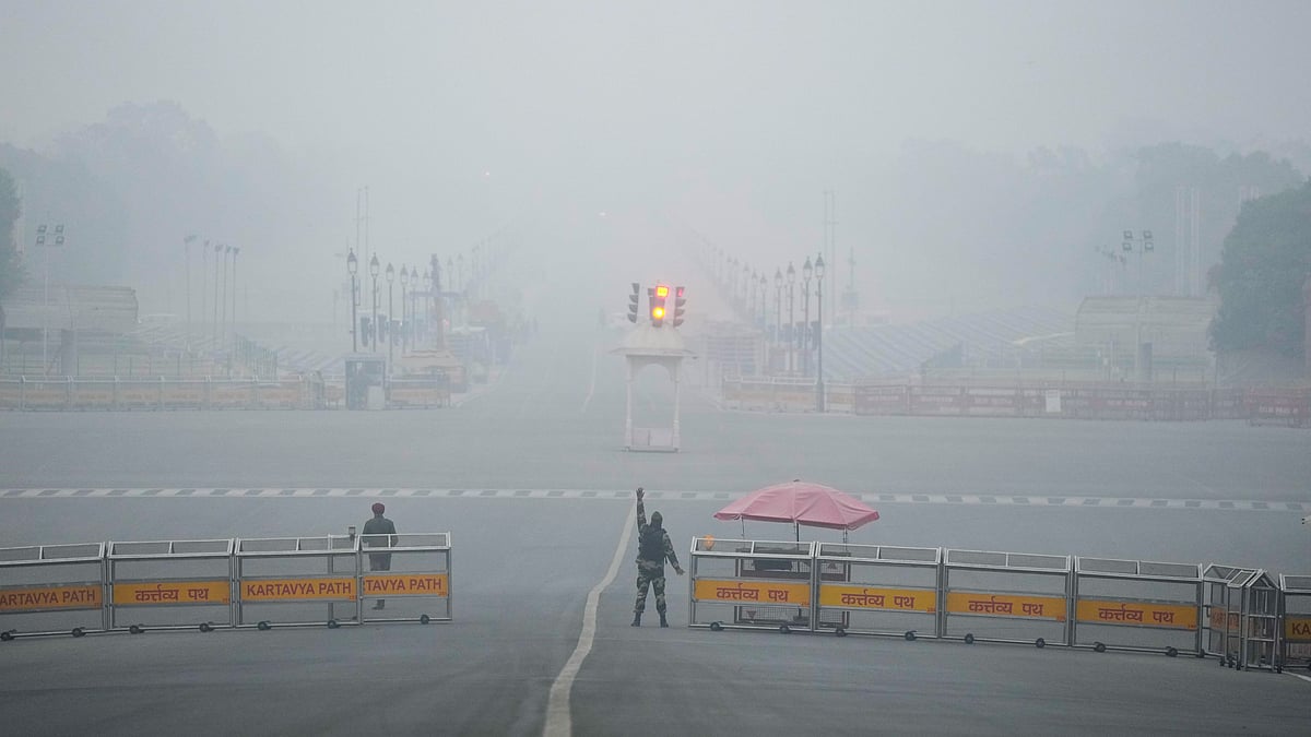 Security personnel stand guard on a foggy winter morning at Vijay Chowk, New Delhi.