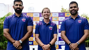 Abhishek Nayar (left) with Meg Lanning and UP Warriorz official