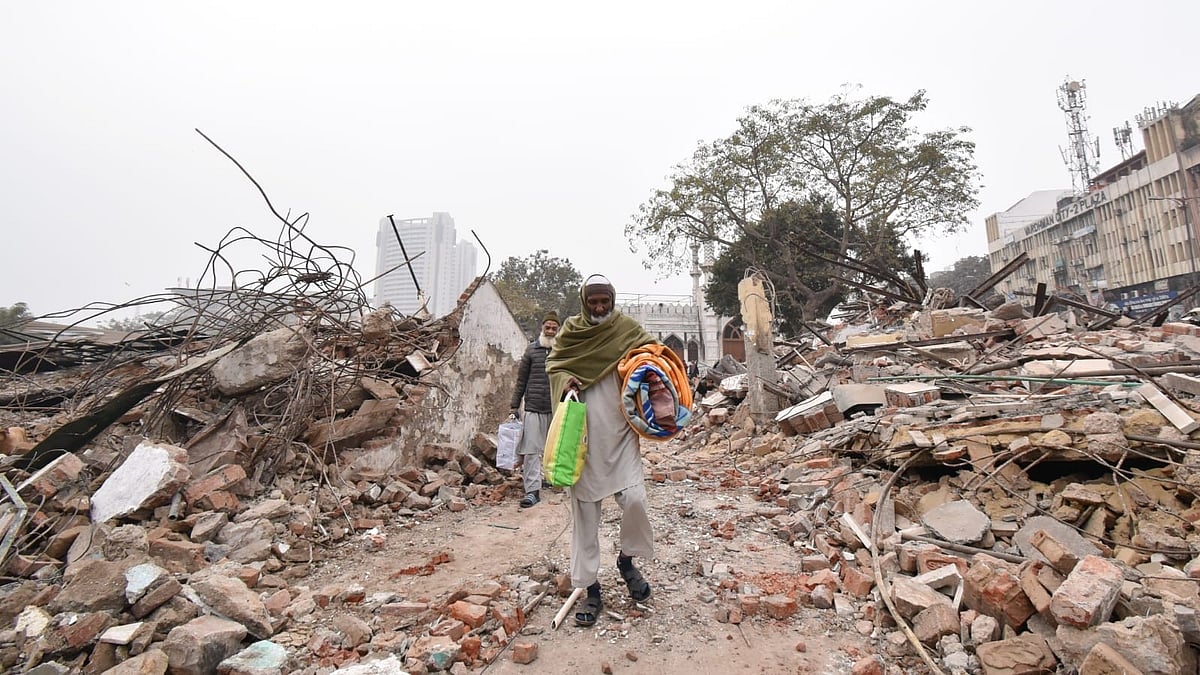 Residents gather their belongings after the demolition drive on 7 January
