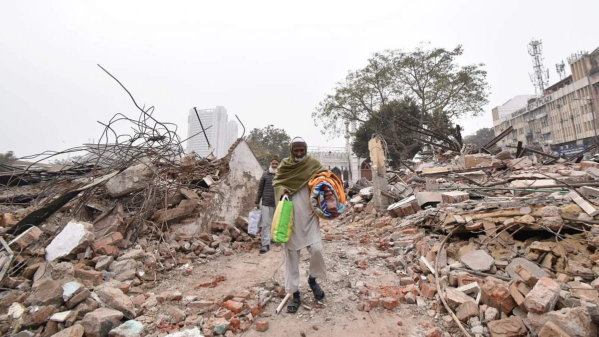 Residents gather their belongings after the demolition drive on 7 January