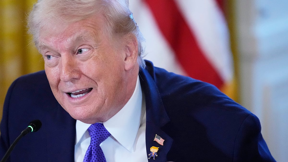 Trump sports the “Happy Trump” pin — diplomacy has a dress code