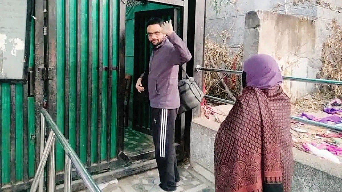 Umar Khalid waves goodbye to his mother at the prison gate in Delhi