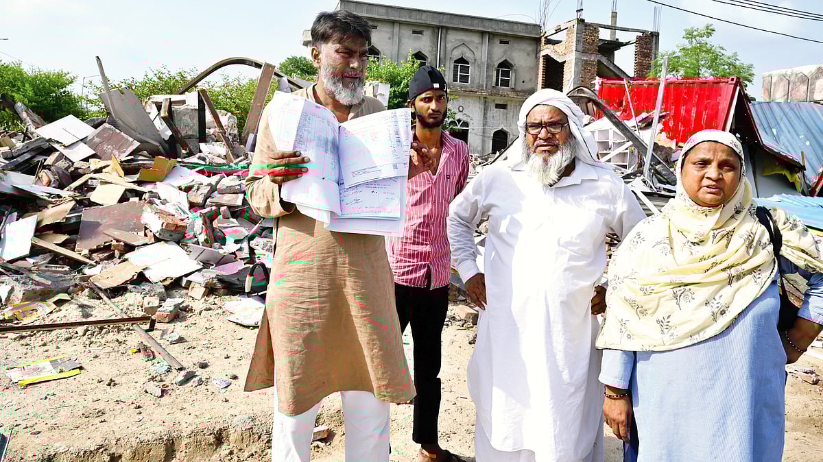 Valid papers offered no protection, as Abdul Rashid, standing outside his demolished shop, found out