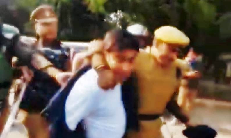 NSUI national president Varun Chaudhary being slammed on the ground by UP Police personnel 