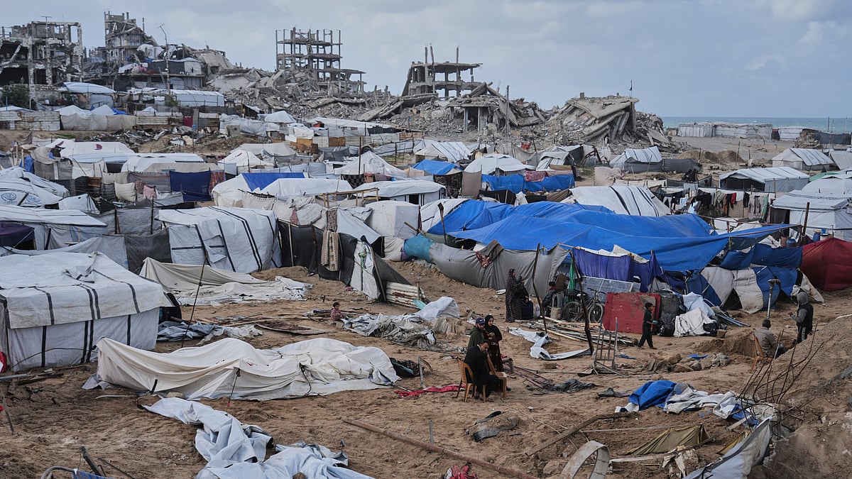 Palestinians inspect damaged tents following an Israeli strike in Gaza City.