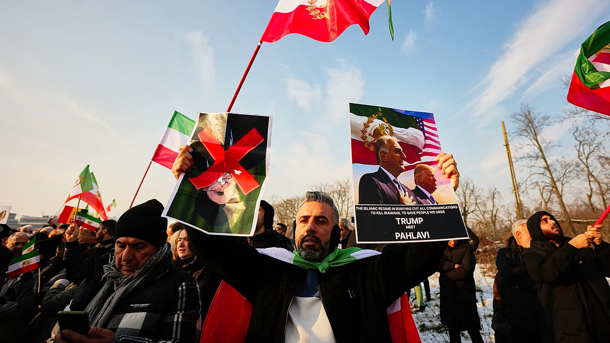 Iranians hold posters of their exiled crown prince and Trump at a rally in Bucharest, Romania, 14 Jan
