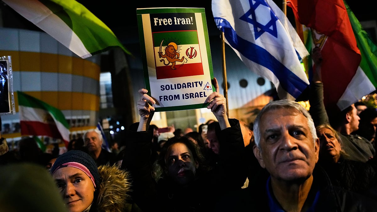 Israeli and pre-revolution Iranian flags at a rally supporting Iran's protests in Holon, Israel