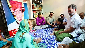 Rahul Gandhi with a bereaved family in Indore