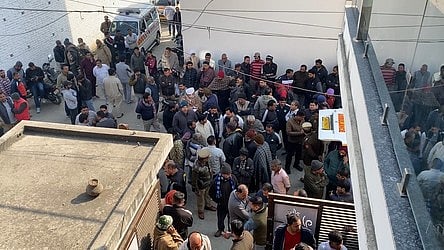 Local residents gather at Kaushik Vihar Colony.