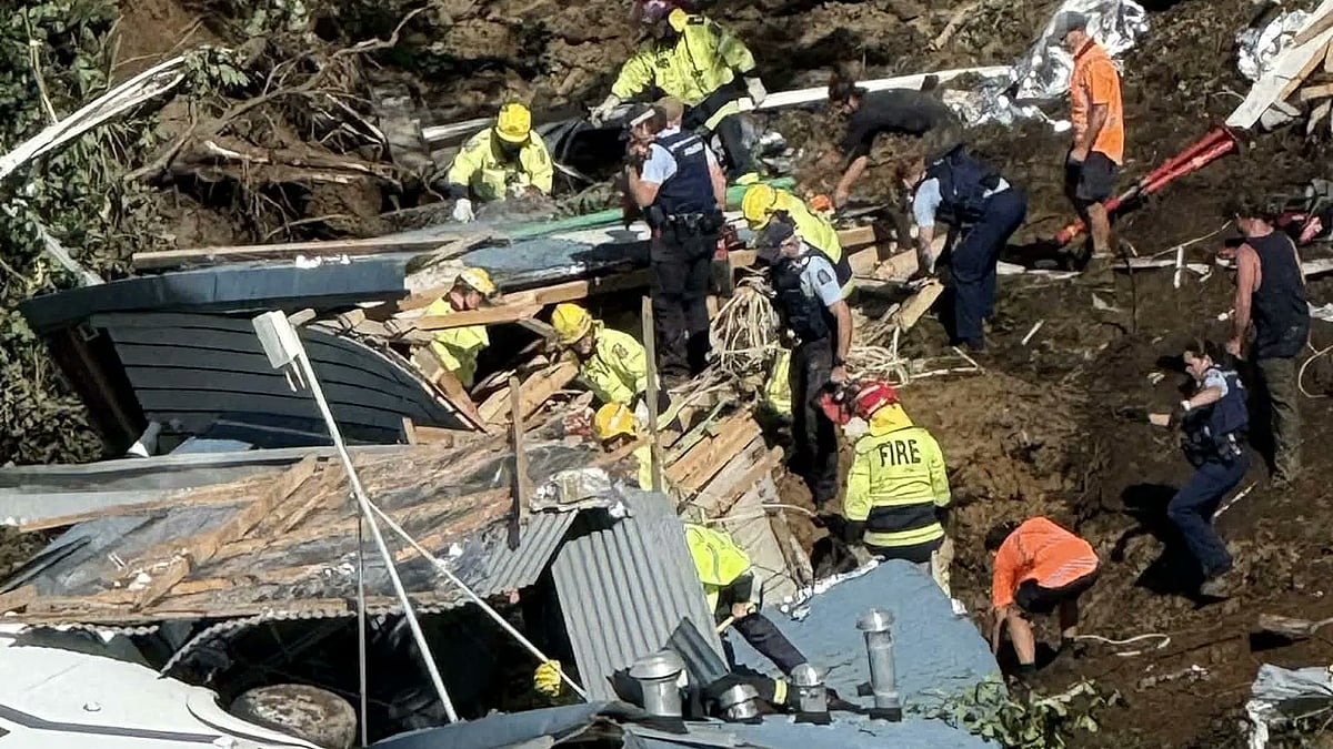 Rescue teams search through debris after a landslide near Mount Maunganui, New Zealand.