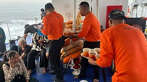 Philippine Coast Guard men assist M/V Trisha Kerstin 3 survivors off Baluk-Baluk Island, Basilan.