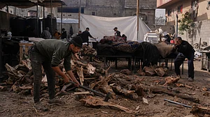 Palestinians gather firewood to cook donated food in Nuseirat, central Gaza.