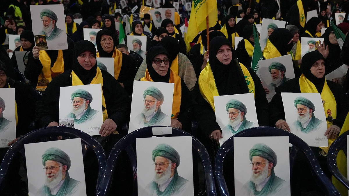 Hezbollah supporters hold portraits of Ayatollah Ali Khamenei at a rally in Beirut.