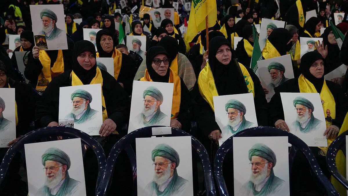 Hezbollah supporters hold portraits of Ayatollah Ali Khamenei at a rally in Beirut.