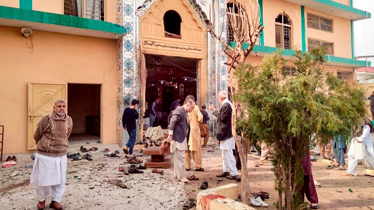 Locals gather at the site after a suicide bomber detonated himself at a mosque in Islamabad.