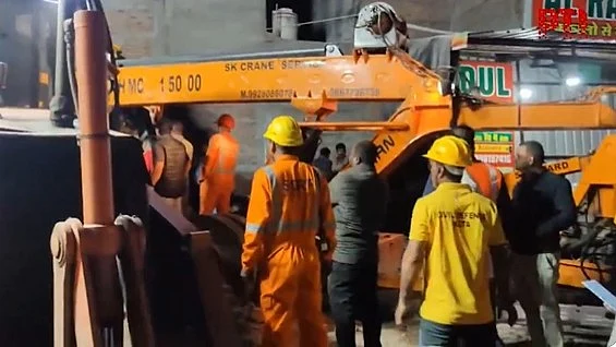 Rescue teams at the building collapse site in Kota.