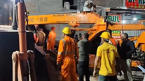 Rescue teams at the building collapse site in Kota.