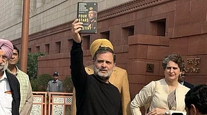 Rahul Gandhi flashes a copy of M.M. Naravane’s unpublished memoir Four Stars of Destiny at Parliament.