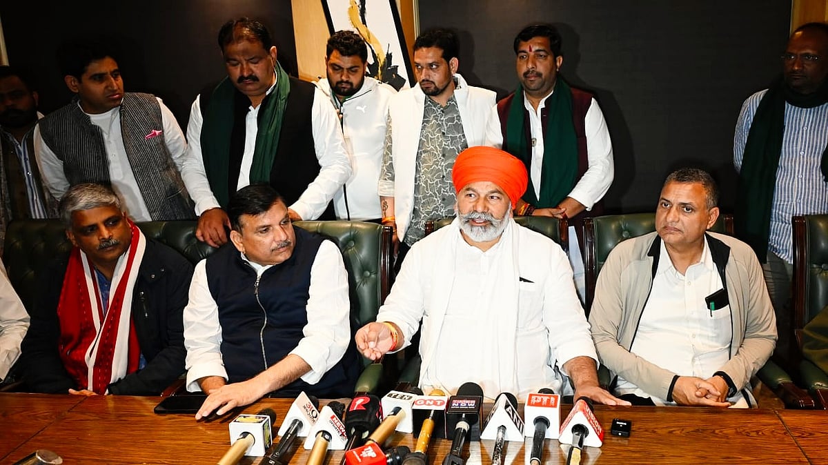 Rakesh Tikait (C) with AAP MP Sanjay Singh and others at Constitution Club of India, New Delhi