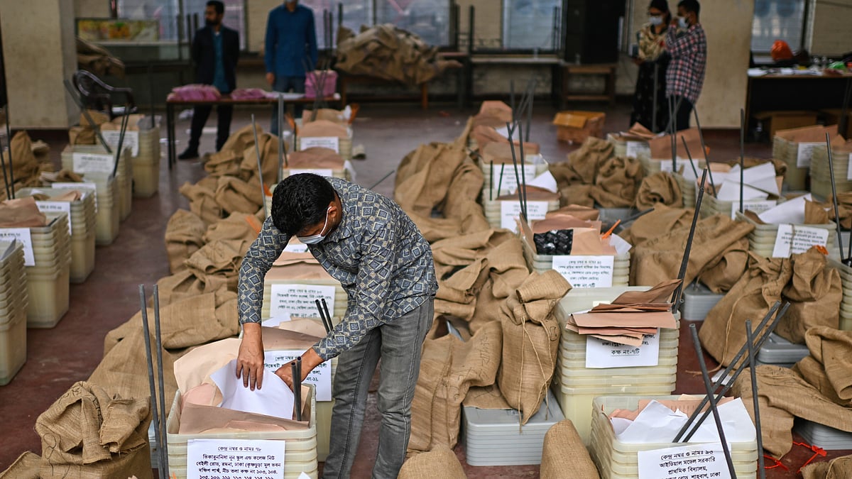 An official checks ballot boxes and voting papers ahead of polling day on 12 February