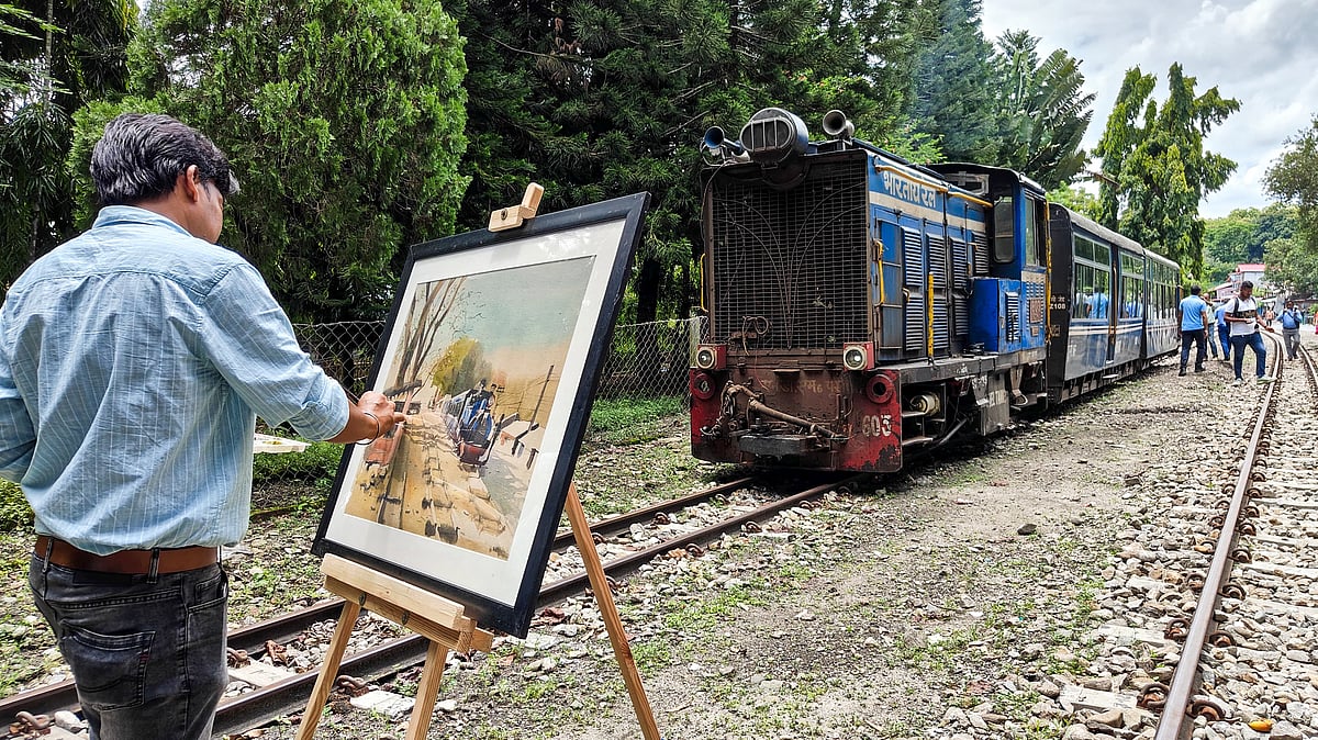 An artist paints the Toy Train at Sukna station near Siliguri.
