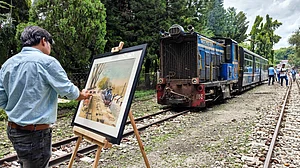 An artist paints the Toy Train at Sukna station near Siliguri.