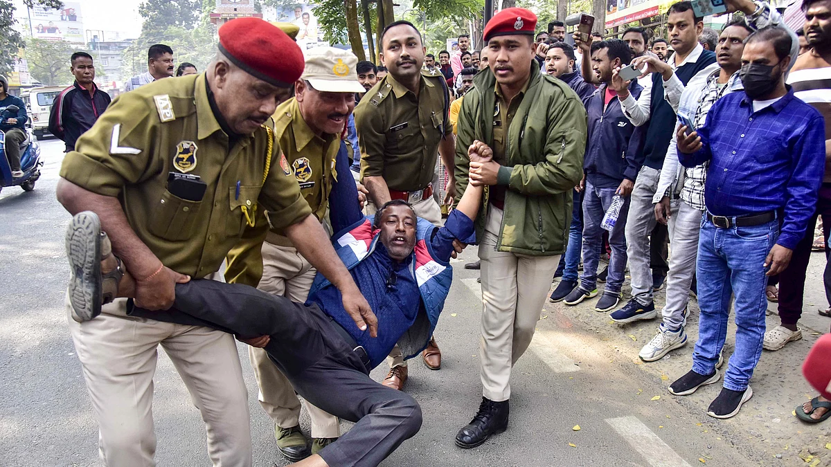 An agitator being detained in Assam's Nagaon during a protest as part of a nationwide strike.
