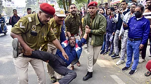 An agitator being detained in Assam's Nagaon during a protest as part of a nationwide strike.