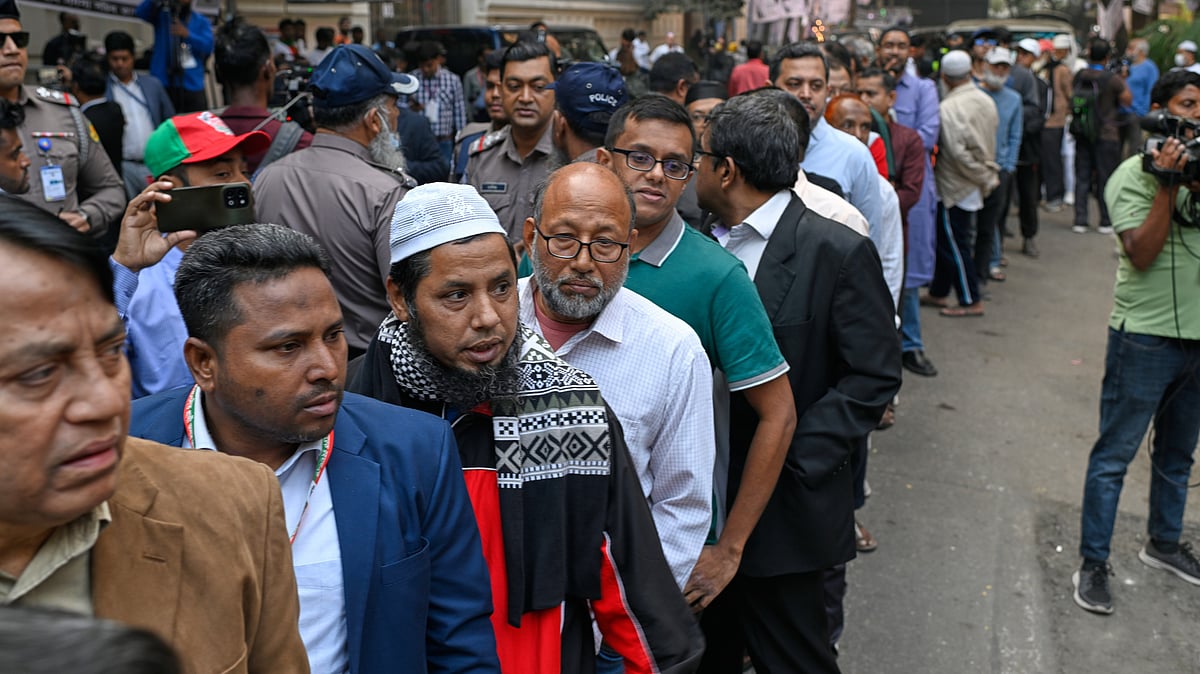 Voters queue outside a polling station in Dhaka.